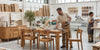 Woodworking workshop with mango wood dining furniture and two workers.